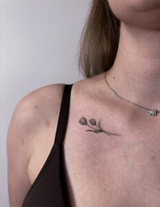 Delikatny kobiecy tatuaż kwiatowy w stylu tiny tattoo – inspiracja 1