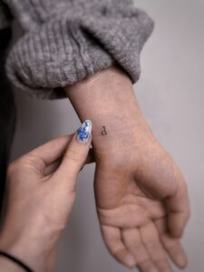 Delikatny tatuaż z napisem w stylu tiny tattoo – inspiracja 1